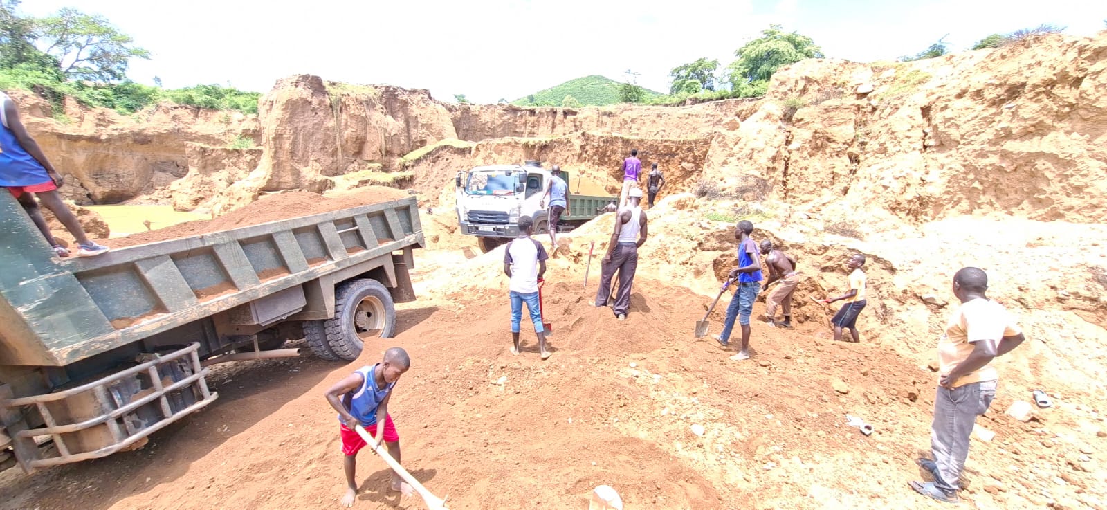 Youth cooperative members safely harvesting and loading sand
